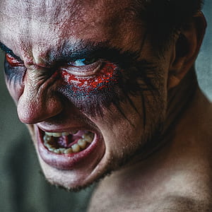 man with black and red cosmetic on eyes thumbnail