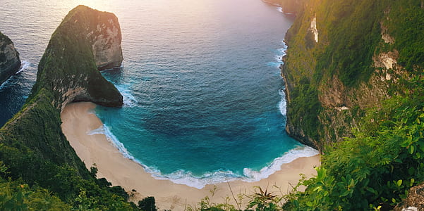body of water beside mountain thumbnail