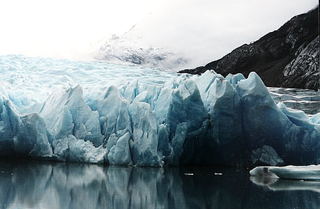 glacier on body of water near mountain thumbnail
