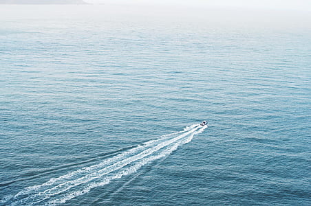 white boat sailing on ocean during daytime thumbnail