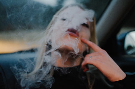 woman blowing smoke inside vehicle thumbnail