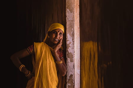 woman wearing traditional Indian dress leaning on wall \ thumbnail