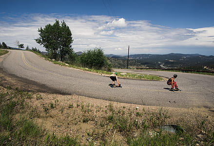 two mens riding longboards thumbnail