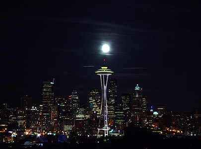 gray concrete tower with buildings during night thumbnail