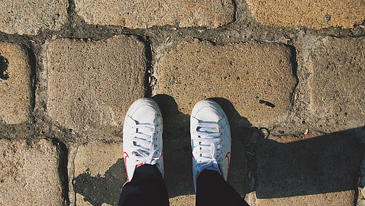person standing on brown concrete floor thumbnail
