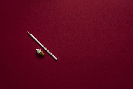 white pencil beside ice cream cone eraser on red platform thumbnail