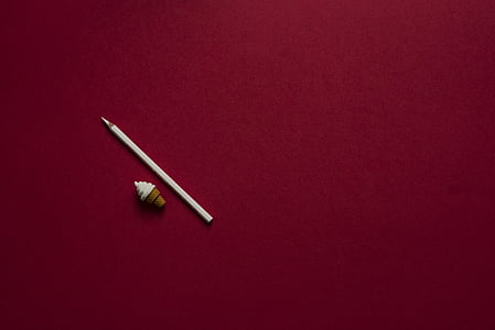 white pencil on brown surface thumbnail