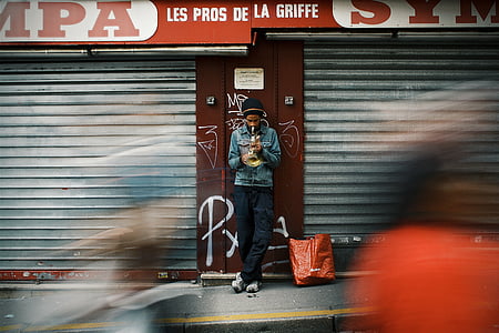 time-lapse photography of man smoking beside store thumbnail