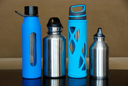 four blue and gray tumblers on black wooden surface thumbnail