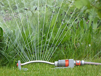 photography of gray and orange water sprinkler near green leafed grass at daytime thumbnail