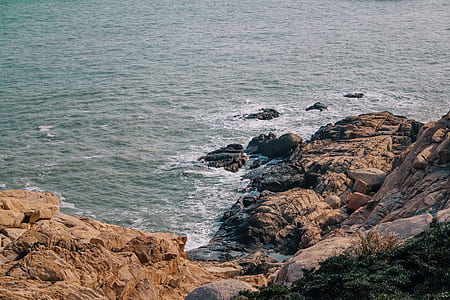 rock formation near body of water thumbnail