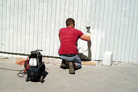 man painting on wall thumbnail