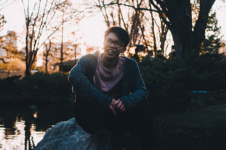 smiling man sitting on rock thumbnail
