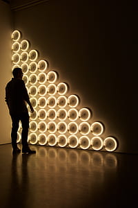 man standing beside wall thumbnail