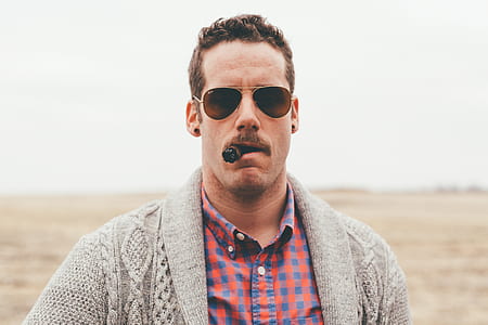 man with tobacco wearing cardigan and sunglasses thumbnail