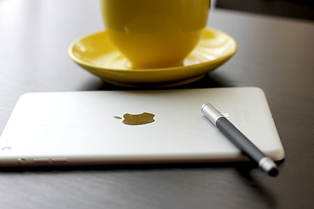 silver iPad near yellow ceramic teacup thumbnail