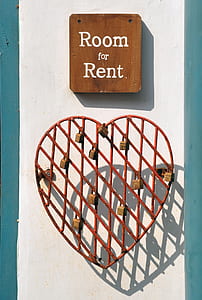 red metal heart wall decor and room for rent board signage mounted on white wall thumbnail