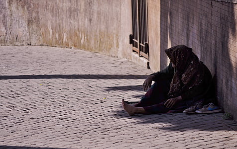 person sitting on floor while leaning on wall during daytime thumbnail