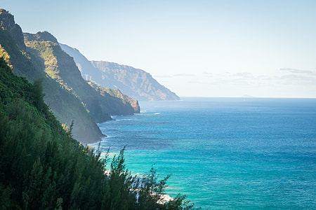 photo of mountain beside seashore thumbnail