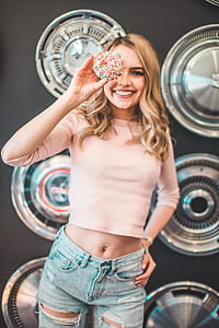woman holding sprinkled doughnut thumbnail