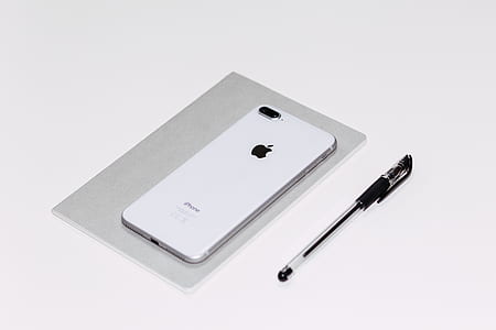 silver iPhone 8 Plus on notebook near pen thumbnail