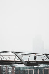 photography of person walking on bridge thumbnail