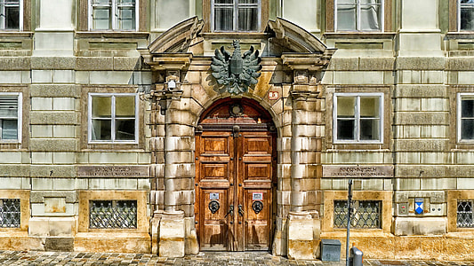 brown wooden paneled double door during daytime thumbnail