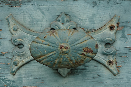 blue and brown metal knob on wooden surface thumbnail