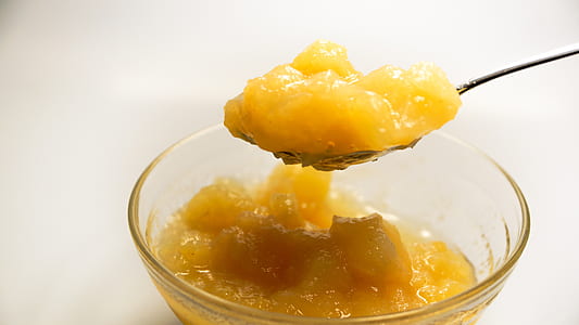 yellow jelly on silver spoon near bowl thumbnail