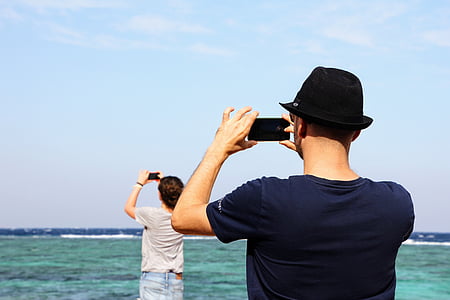 person taking photo of another person taking a photo thumbnail