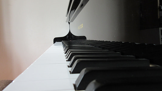 shallow focus photography of black and white upright piano thumbnail