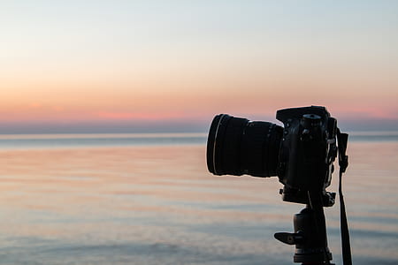black DSLR camera with stand during golden hour thumbnail