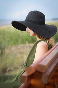 selective focus photography of woman wearing black sun hat thumbnail