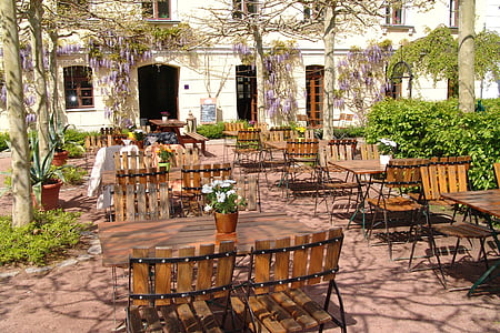 building in front of tables and chairs thumbnail