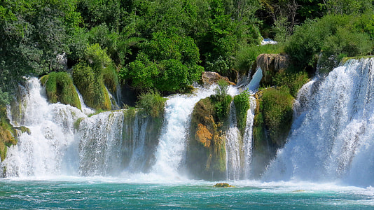 cascading waterfalls surrounded by forest thumbnail