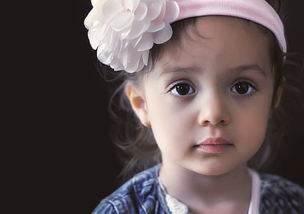 baby wears pink floral headdress thumbnail