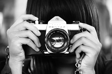 Woman Holding Dslr Camera in Grayscale Photography thumbnail