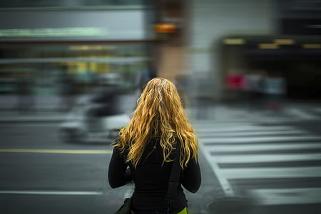timelapse photography of woman walking at the pedestrian lane thumbnail