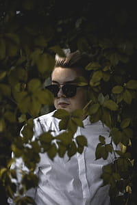 Man Standing Behind Leaves thumbnail