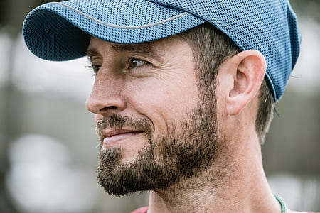 closed-lips smiling man wearing blue cap thumbnail