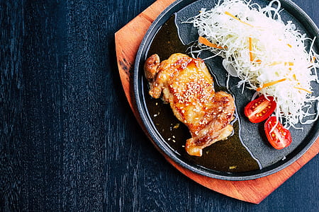 flat-lay photography of roasted chicken with two slice of tomatoes at hotplate thumbnail