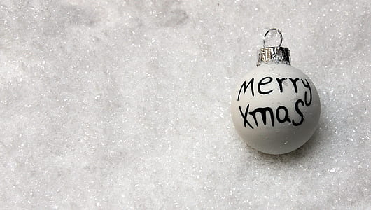 Merry Xmas printed bauble on silver surface thumbnail