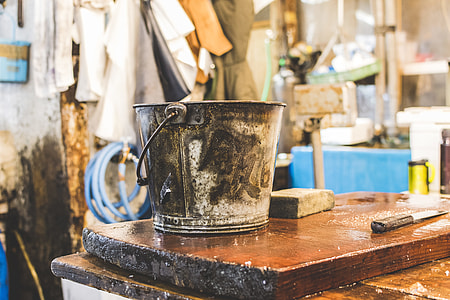 gray metal bucket on brown wooden board thumbnail