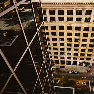 high angled photography of building near street with vehicles on front of other building thumbnail
