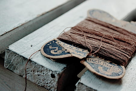 tilt shift lens photography of brown thread on gray wooden planks thumbnail