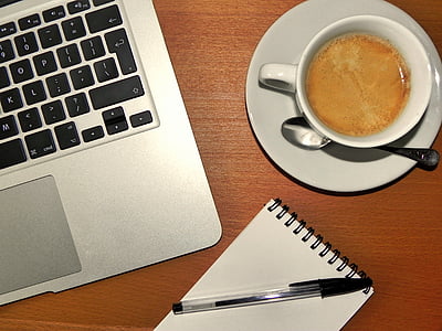 coffee on mug, by the pen and laptop thumbnail