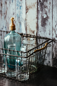 Collection of bottles in metal mesh basket thumbnail