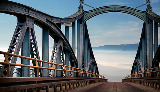 gray and brown suspension bridge under blue sky thumbnail