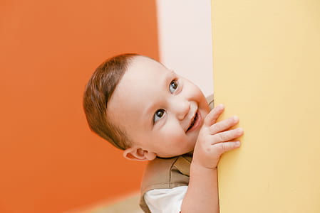 baby touching yellow wall thumbnail