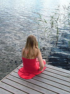 woman seat near water thumbnail